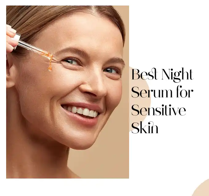 Mature woman smiling while applying a night serum with a dropper near the outer eye, skin looks hydrated and healthy