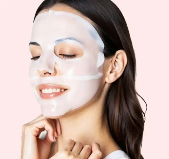 model with hand under chin on pale-pink background (clean, minimal composition)